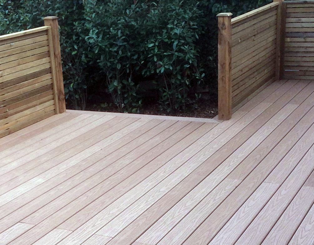 Image shows a newly installed deck with fencing. Image depicts Thomas Charles Landscapes' garden & landscaping services