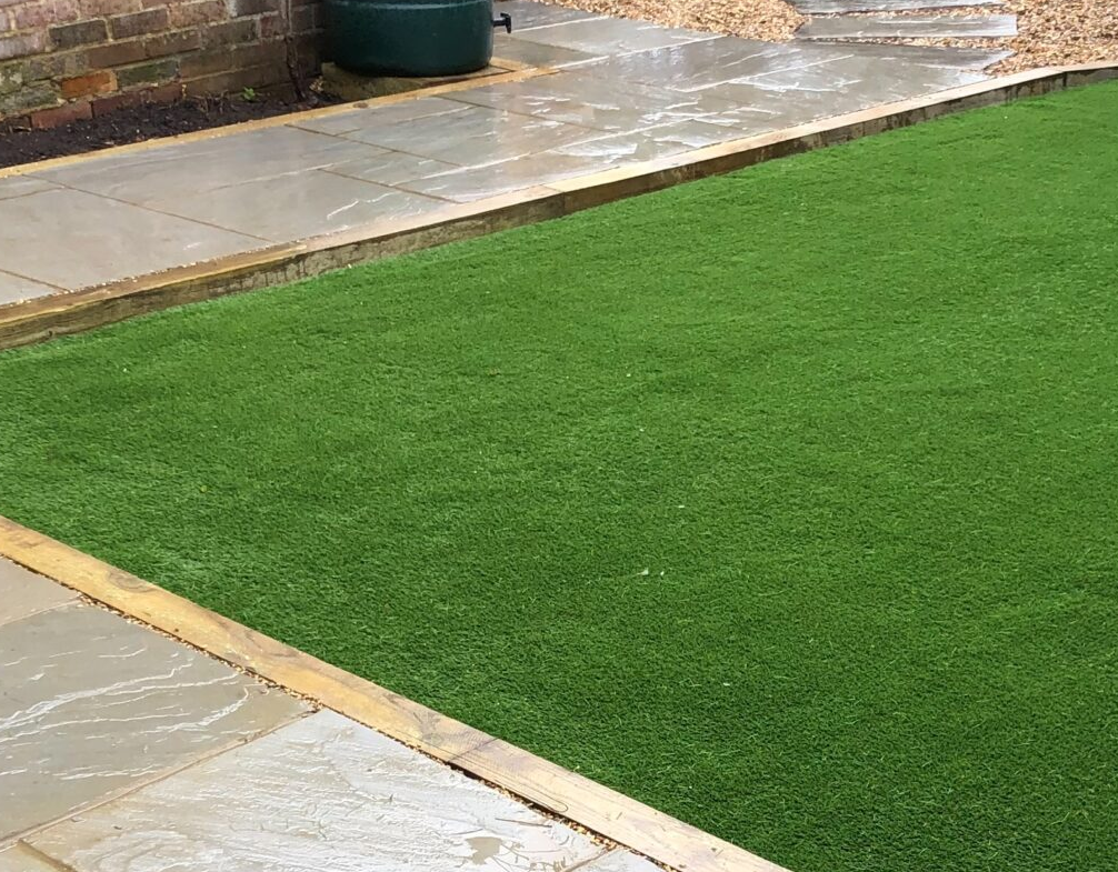 Image shows a lawn newly laid with artificial turf. Image depicts Thomas Charles Landscapes' garden & landscaping services