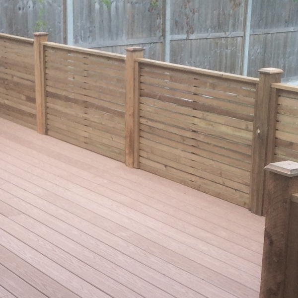 Image shows contemporary slatted fencing installed by fencing contractors