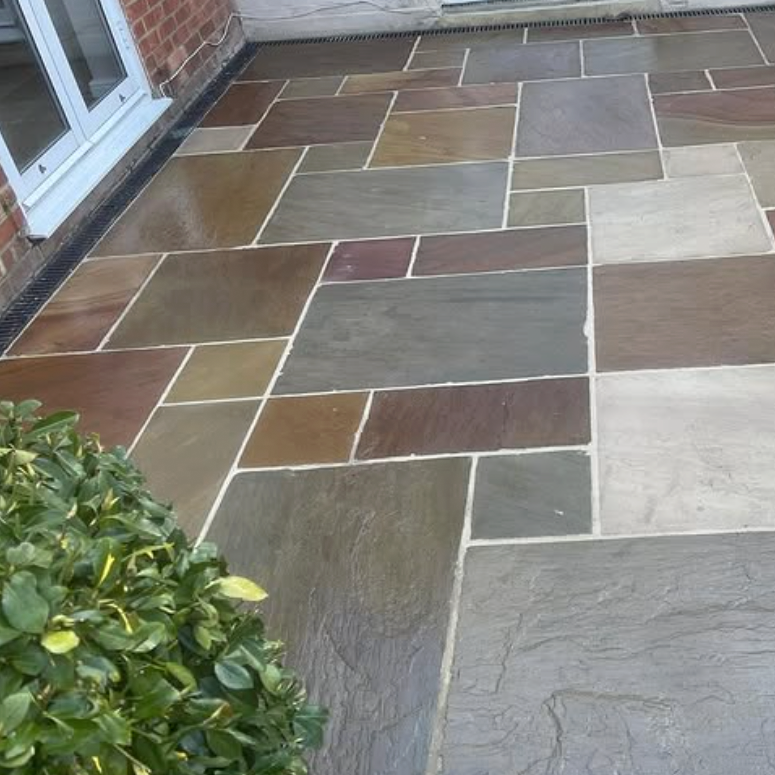 image shows a newly laid natural stone patio in Hertfordshire