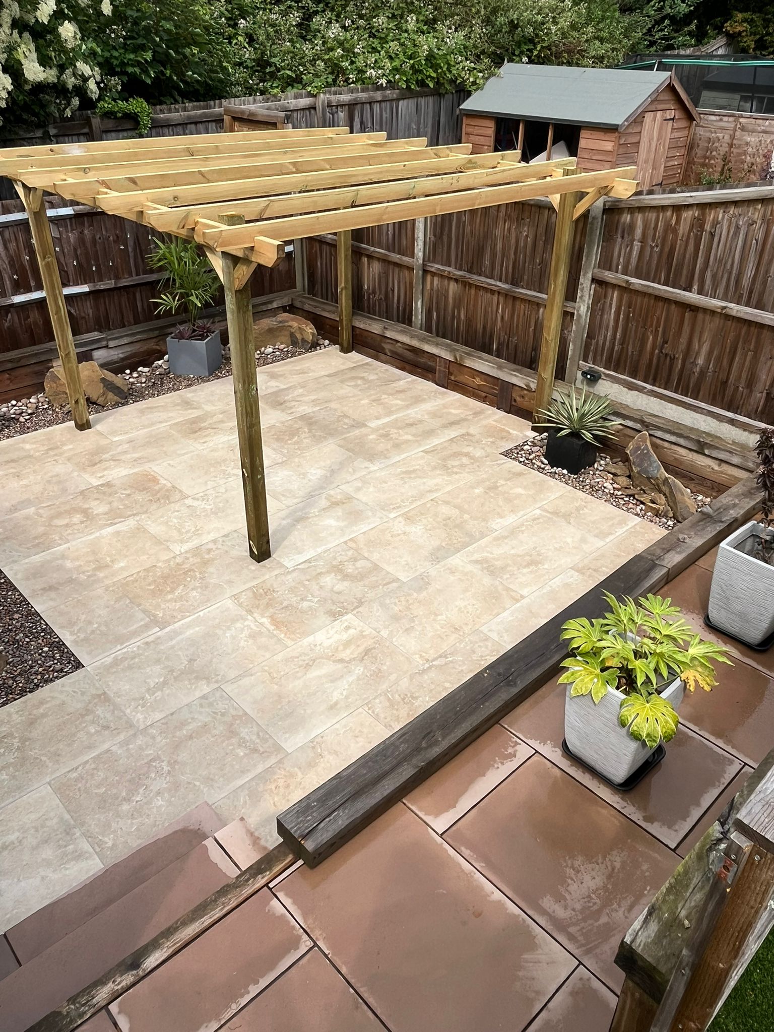 Image shows a patio with pergola, image depicts garden landscapers near me