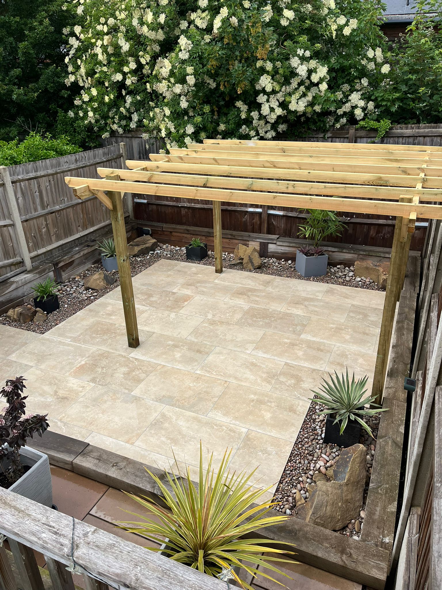 Image shows a patio and pergola. Images depicts Thomas Charles Landscapes' services