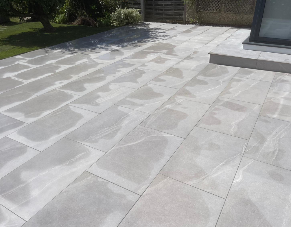 Image shows a newly installed patio with step. Image depicts Thomas Charles Landscapes' garden & landscaping services